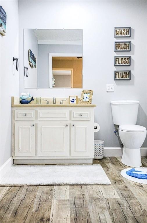 111 Runner Rd, Savannah, GA 31410 - bathroom with baseboards, toilet, vanity, and wood finished floors