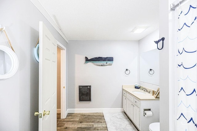 111 Runner Rd, Savannah, GA 31410 - full bathroom with heating unit, vanity, toilet, wood finished floors, and baseboards