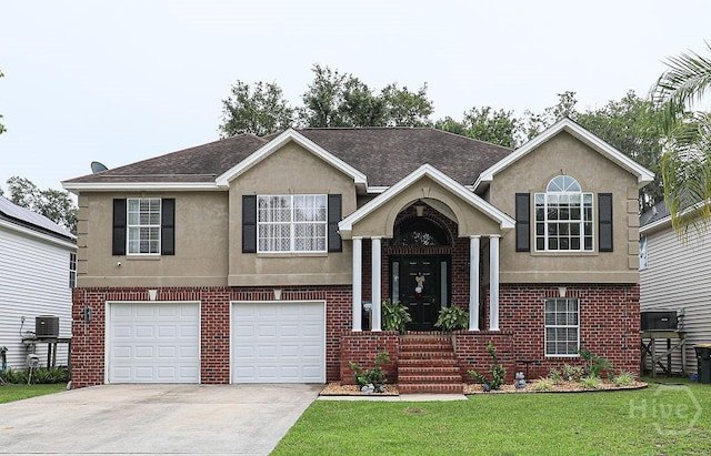 111 Runner Rd, Savannah, GA 31410 - view of front facade with driveway, brick siding, a front lawn, a garage, and stucco siding