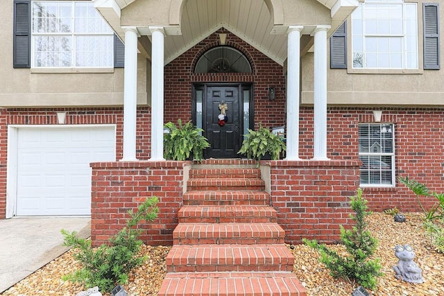 111 Runner Rd, Savannah, GA 31410 - view of exterior entry with brick siding, a garage, and driveway