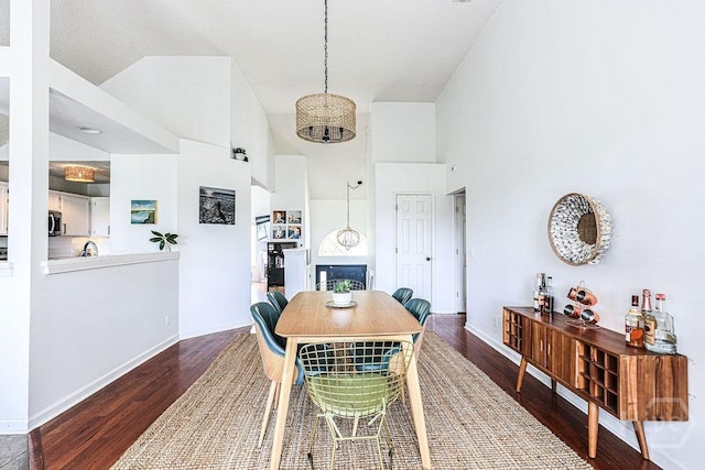 111 Runner Rd, Savannah, GA 31410 - dining area featuring a chandelier, wood finished floors, a towering ceiling, and baseboards