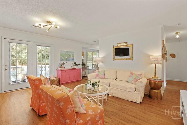 5109 Laroche Ave, Savannah, GA 31404 - living area with light wood-type flooring, crown molding, baseboards, and a textured ceiling