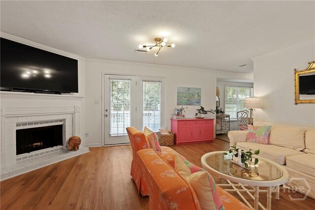 5109 Laroche Ave, Savannah, GA 31404 - living area with light wood finished floors, a textured ceiling, ornamental molding, and a fireplace