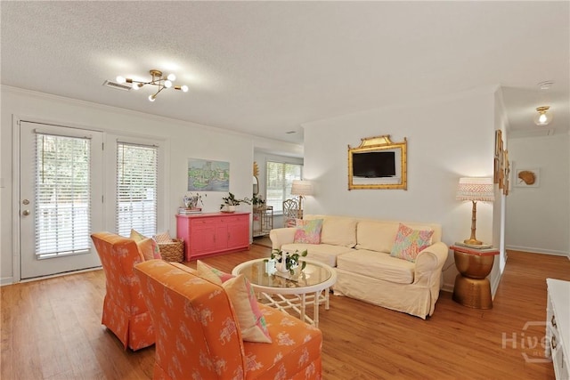 5109 Laroche Ave, Savannah, GA 31404 - living area with light wood-type flooring, crown molding, baseboards, and a textured ceiling