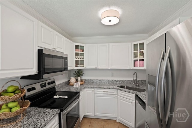 5109 Laroche Ave, Savannah, GA 31404 - kitchen featuring stainless steel appliances, a sink, glass insert cabinets, white cabinetry, and a textured ceiling