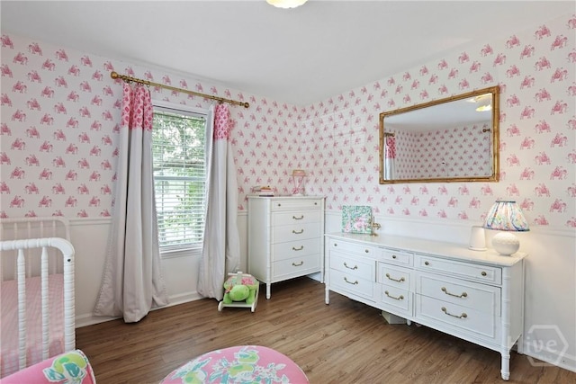 5109 Laroche Ave, Savannah, GA 31404 - bedroom with wallpapered walls, a wainscoted wall, and wood finished floors