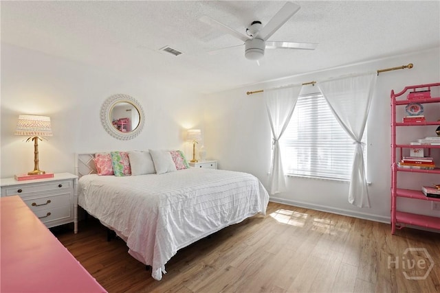 5109 Laroche Ave, Savannah, GA 31404 - bedroom with wood finished floors, baseboards, a ceiling fan, and a textured ceiling