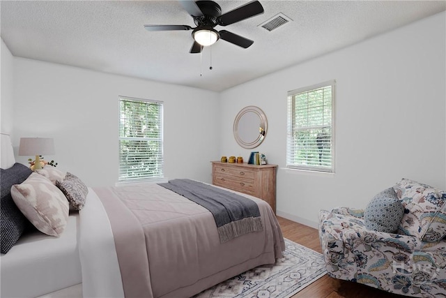 5109 Laroche Ave, Savannah, GA 31404 - bedroom featuring wood finished floors, a textured ceiling, and ceiling fan