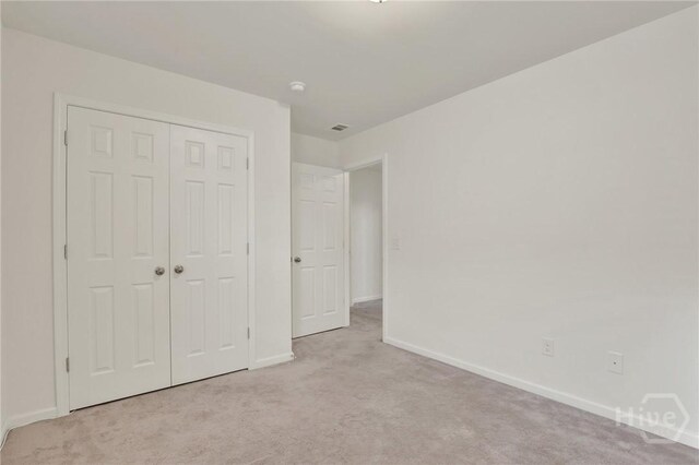 106 Tanzania Trl, Pooler, GA 31322 - unfurnished bedroom with light colored carpet, baseboards, and a closet
