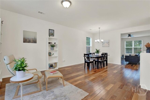106 Tanzania Trl, Pooler, GA 31322 - dining area featuring wood finished floors, a chandelier, baseboards, and a ceiling fan