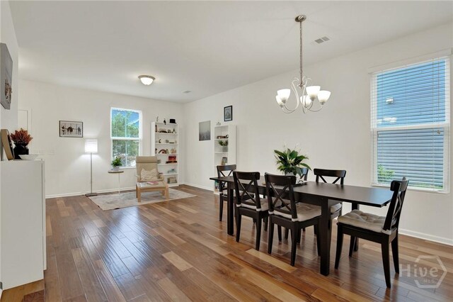 106 Tanzania Trl, Pooler, GA 31322 - dining room with wood-type flooring, a chandelier, and baseboards