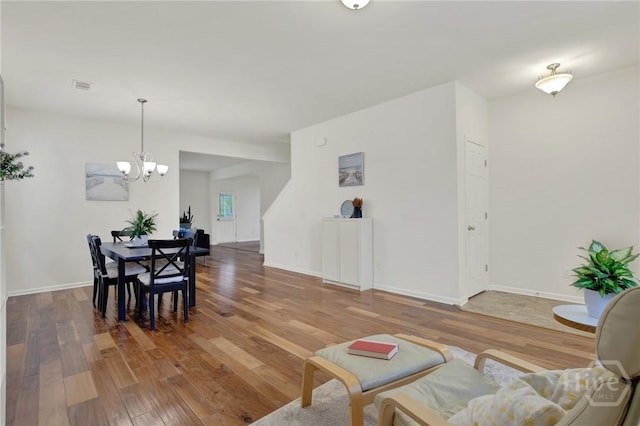 106 Tanzania Trl, Pooler, GA 31322 - dining space featuring a chandelier, wood finished floors, and baseboards