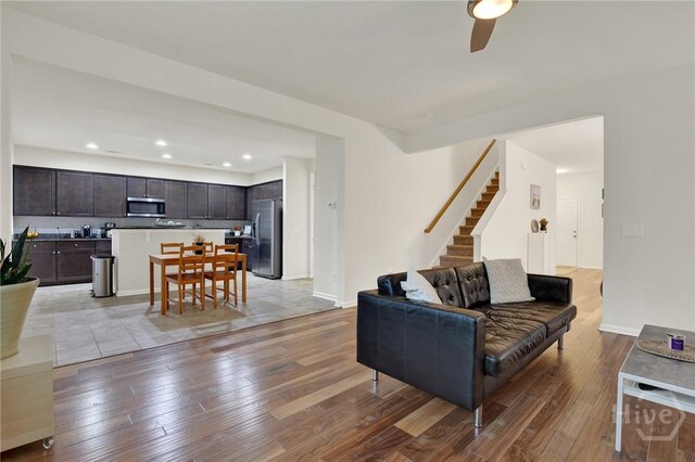 106 Tanzania Trl, Pooler, GA 31322 - living area featuring light wood-type flooring, a ceiling fan, stairs, baseboards, and recessed lighting