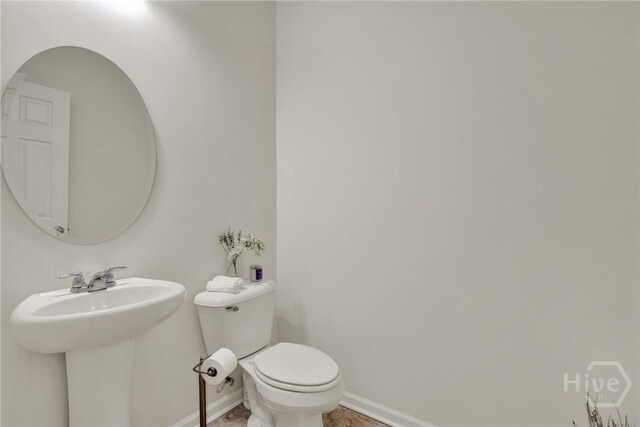 106 Tanzania Trl, Pooler, GA 31322 - half bathroom featuring baseboards, toilet, and a sink