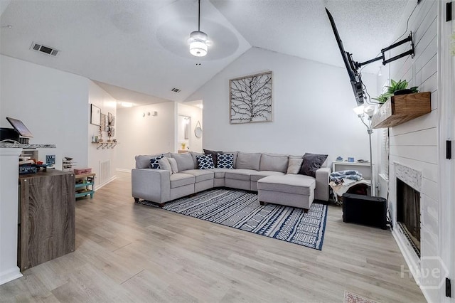 5 Sugar Cane Dr, Savannah, GA 31419 - living room featuring ceiling fan, light wood-style floors, vaulted ceiling, and a large fireplace