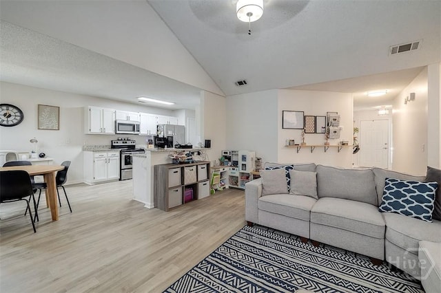 5 Sugar Cane Dr, Savannah, GA 31419 - living area featuring light wood-style flooring, ceiling fan, and high vaulted ceiling
