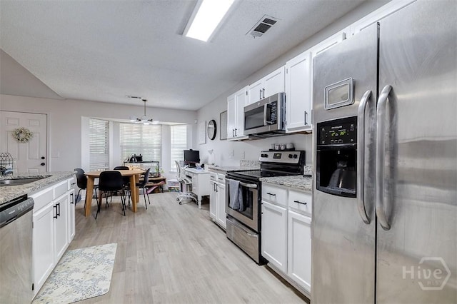 5 Sugar Cane Dr, Savannah, GA 31419 - kitchen with stainless steel appliances, white cabinetry, and light wood-type flooring