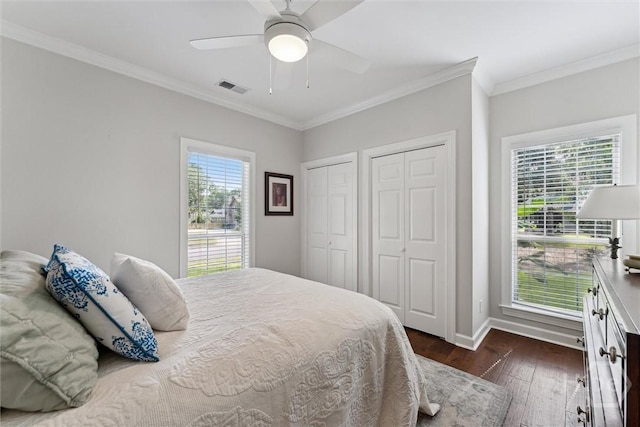 2 Dalry Ln, Savannah, GA 31419 - bedroom featuring two closets, dark wood-type flooring, baseboards, crown molding, and a ceiling fan