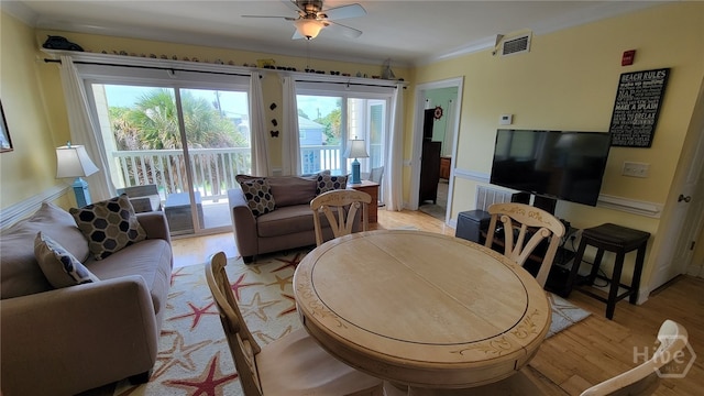 18 Silver Ave Unit 4, Tybee Island, GA 31328 - living room featuring light wood-style floors, crown molding, a ceiling fan, and plenty of natural light