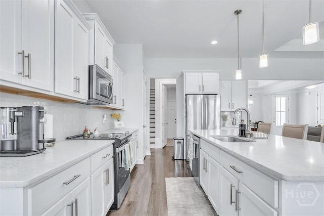 214 Park Chase Chase, Pooler, GA 31322 - kitchen with appliances with stainless steel finishes, a sink, an island with sink, tasteful backsplash, and wood finished floors