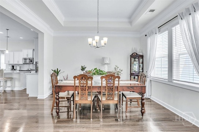 214 Park Chase Chase, Pooler, GA 31322 - dining space featuring a raised ceiling, wood finished floors, a chandelier, baseboards, and ornamental molding