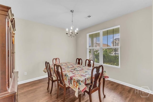 413 Lions Den Dr, Pooler, GA 31322 - dining area with dark wood-type flooring, baseboards, and a chandelier