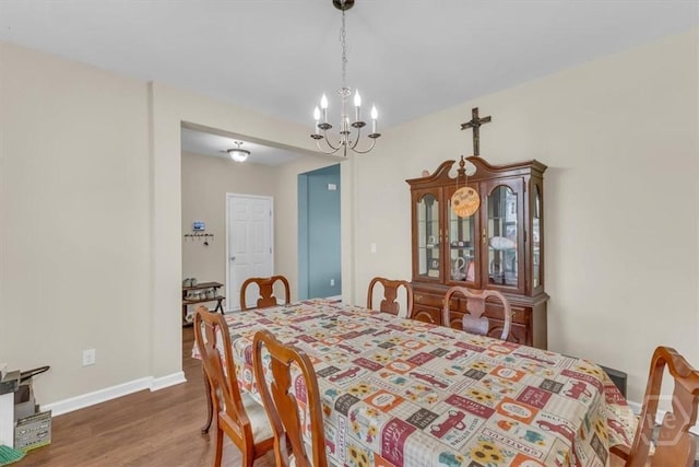 413 Lions Den Dr, Pooler, GA 31322 - dining area with a chandelier, wood finished floors, and baseboards
