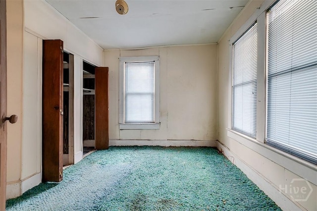 1023 W 37th St, Savannah, GA 31415 - unfurnished bedroom with carpet floors and multiple windows
