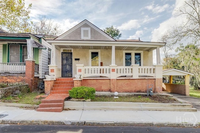 1023 W 37th St, Savannah, GA 31415 - view of front of home with covered porch, stucco siding, and a detached carport