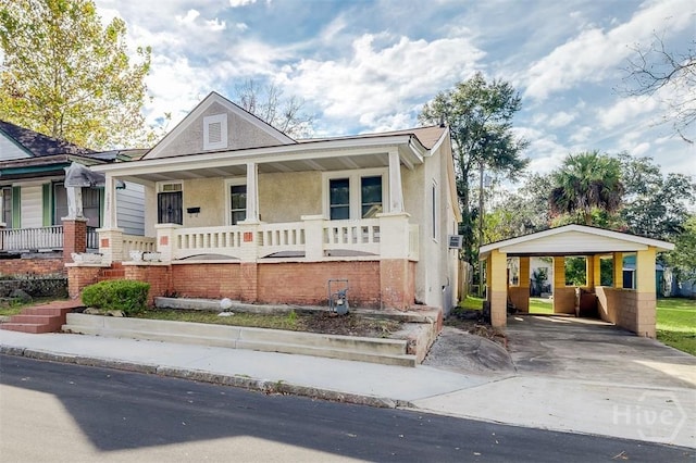 1023 W 37th St, Savannah, GA 31415 - view of front of home with covered porch, driveway, stucco siding, and a carport
