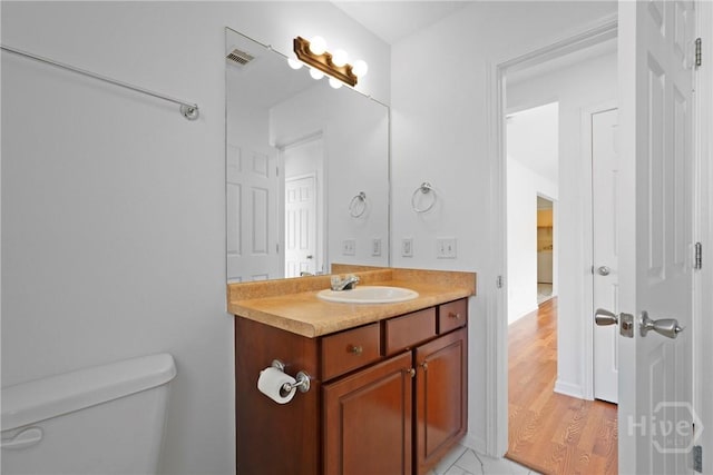 315 S Bridgeport Dr, Statesboro, GA 30461 - bathroom featuring toilet, vanity, and wood finished floors