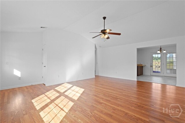 315 S Bridgeport Dr, Statesboro, GA 30461 - unfurnished living room with lofted ceiling, light wood-style floors, a chandelier, and ceiling fan