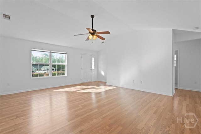 315 S Bridgeport Dr, Statesboro, GA 30461 - unfurnished living room featuring a ceiling fan, vaulted ceiling, light wood-type flooring, and baseboards