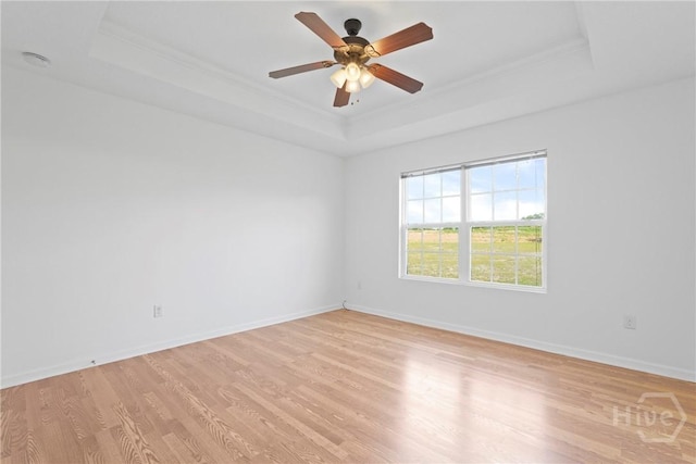 315 S Bridgeport Dr, Statesboro, GA 30461 - spare room featuring a tray ceiling, ornamental molding, light wood-style flooring, baseboards, and a ceiling fan