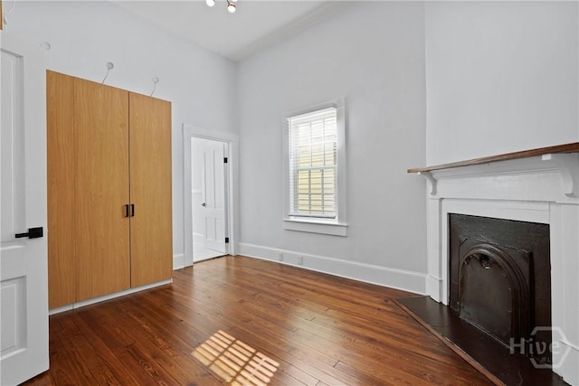 710 W 36th St, Savannah, GA 31415 - unfurnished living room with hardwood / wood-style flooring, a fireplace, and baseboards