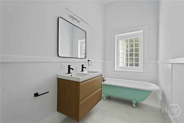 710 W 36th St, Savannah, GA 31415 - full bath featuring a freestanding bath, double vanity, wainscoting, and marble finish flooring