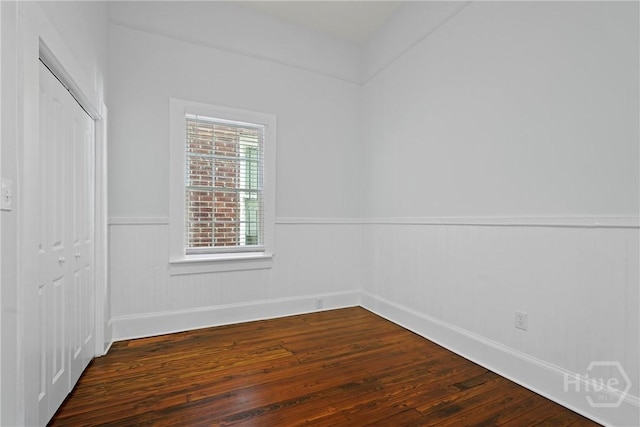 710 W 36th St, Savannah, GA 31415 - unfurnished bedroom featuring wainscoting, a closet, dark wood-type flooring, and baseboards