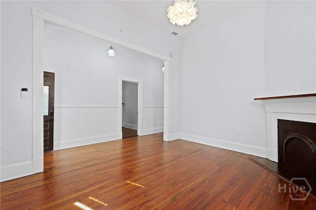 710 W 36th St, Savannah, GA 31415 - unfurnished living room featuring hardwood / wood-style flooring, a fireplace, and baseboards