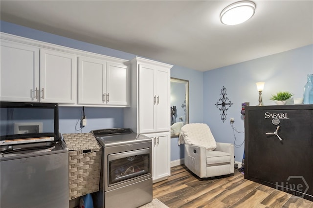 4000 Old River Rd S, Brooklet, GA 30415 - laundry room featuring washer and clothes dryer, cabinet space, and wood finished floors