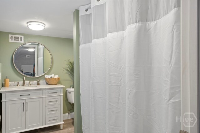 4000 Old River Rd S, Brooklet, GA 30415 - full bathroom with vanity, toilet, and wood finished floors