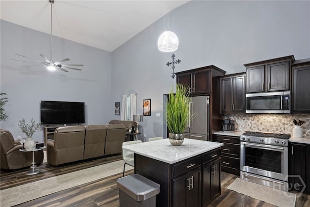 4000 Old River Rd S, Brooklet, GA 30415 - kitchen featuring appliances with stainless steel finishes, high vaulted ceiling, open floor plan, backsplash, and dark wood finished floors