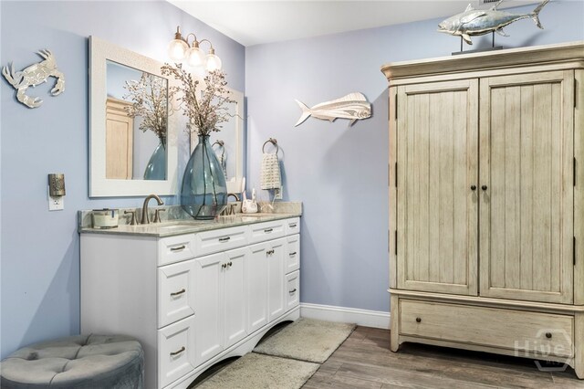 4000 Old River Rd S, Brooklet, GA 30415 - bathroom with double vanity, wood finished floors, and baseboards
