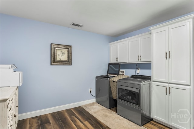 4000 Old River Rd S, Brooklet, GA 30415 - laundry area with cabinet space, baseboards, dark wood-type flooring, and washer and clothes dryer