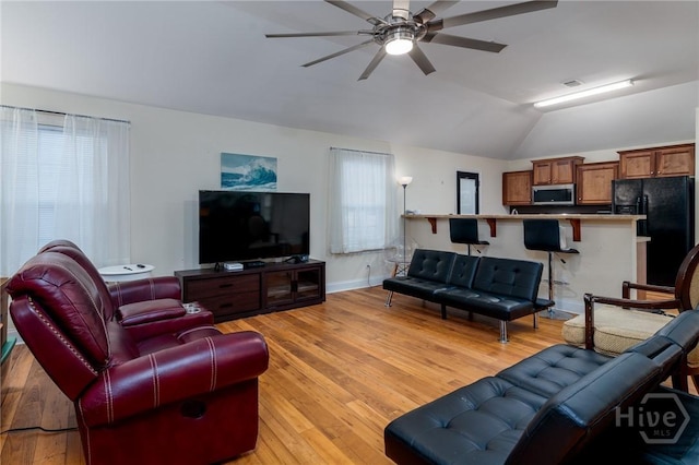 157 Stonebrook Way, Statesboro, GA 30458 - living room featuring vaulted ceiling, ceiling fan, light wood-style floors, and baseboards