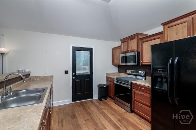 157 Stonebrook Way, Statesboro, GA 30458 - kitchen with appliances with stainless steel finishes, a sink, wood finished floors, light countertops, and vaulted ceiling
