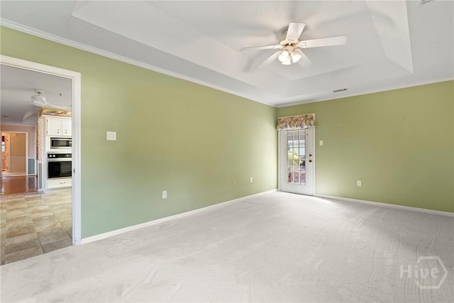 145 Cardinal Rd, Savannah, GA 31406 - spare room featuring a tray ceiling, a ceiling fan, ornamental molding, baseboards, and light carpet