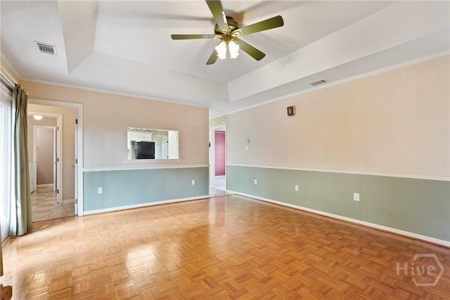 145 Cardinal Rd, Savannah, GA 31406 - unfurnished living room featuring a tray ceiling, ceiling fan, baseboards, and wainscoting