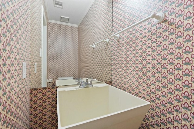145 Cardinal Rd, Savannah, GA 31406 - bathroom with ornamental molding, a sink, a freestanding tub, and wallpapered walls