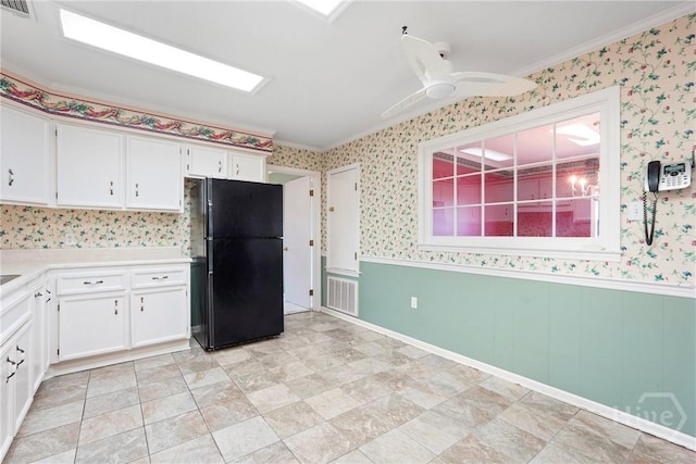 145 Cardinal Rd, Savannah, GA 31406 - kitchen featuring freestanding refrigerator, wallpapered walls, light countertops, white cabinets, and crown molding