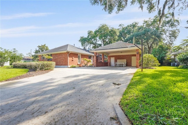 145 Cardinal Rd, Savannah, GA 31406 - view of front of property featuring concrete driveway, brick siding, a front yard, and a carport